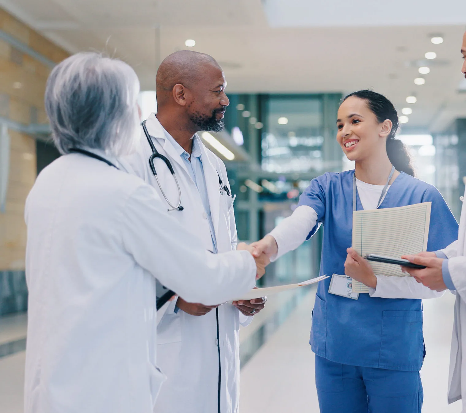 Nurse Shaking Hands with Doctor During Medical Team Briefing